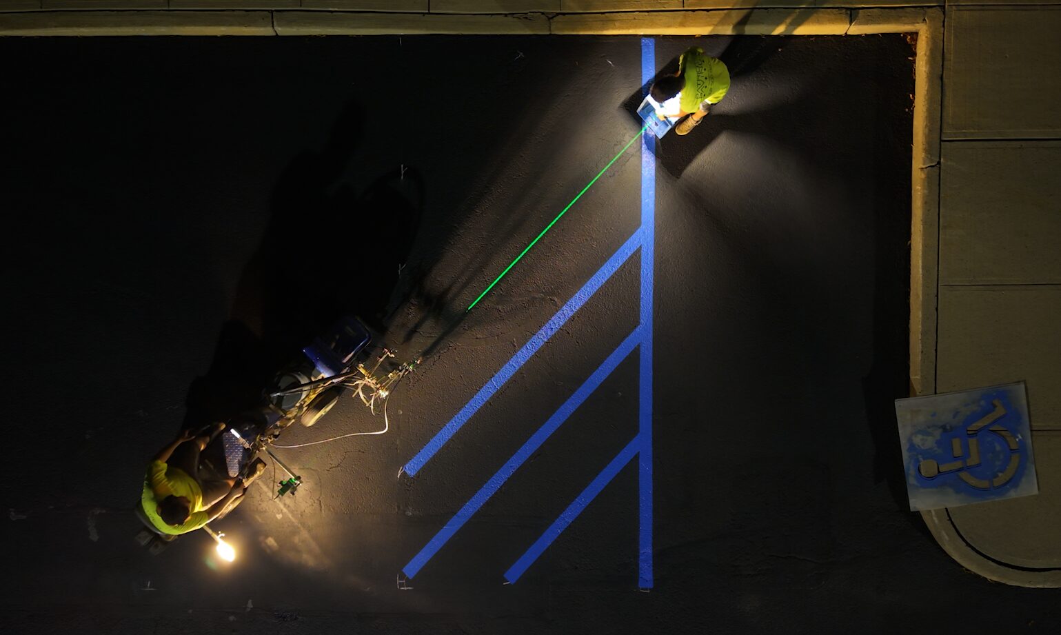 Laser-guided ADA line striping on commercial parking lot