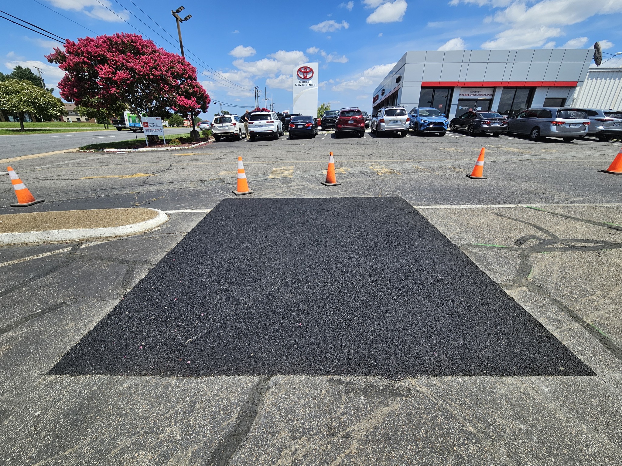 Sealed asphalt patch seams protecting repair from water intrusion