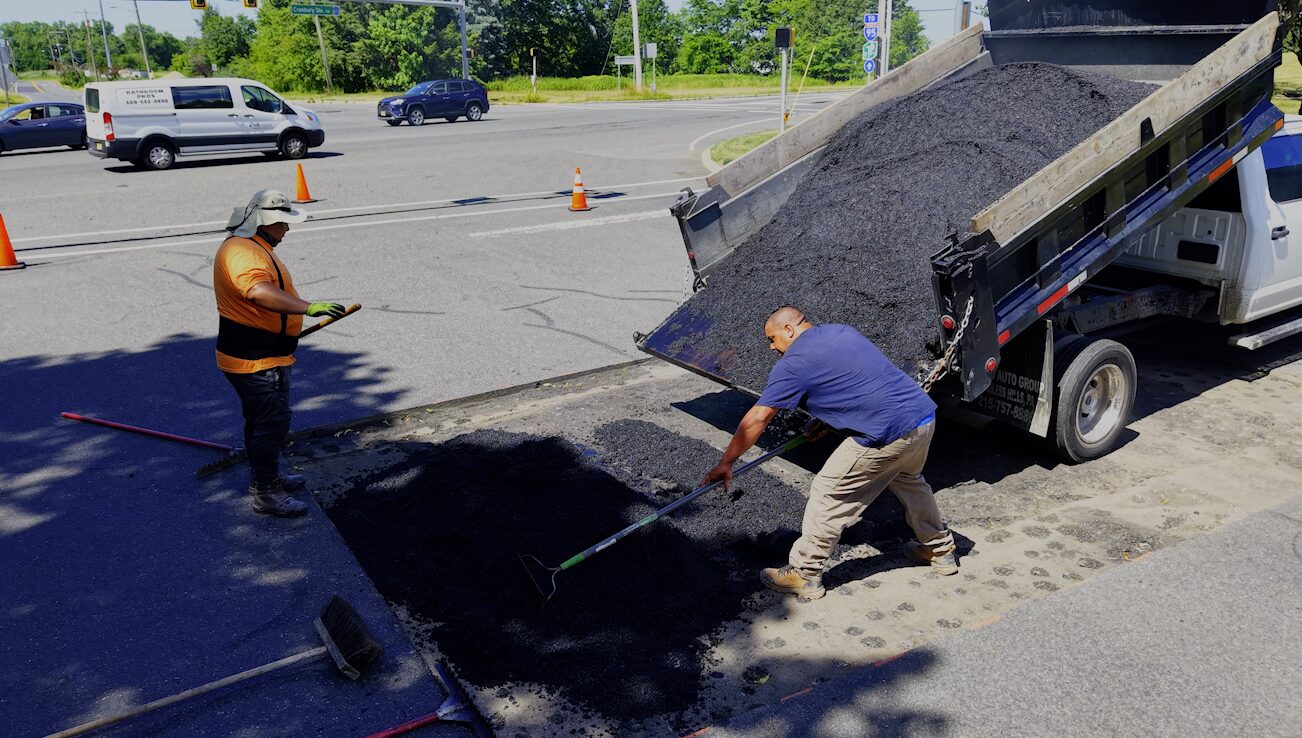 Hot asphalt patchwork and pothole repair on commercial lot