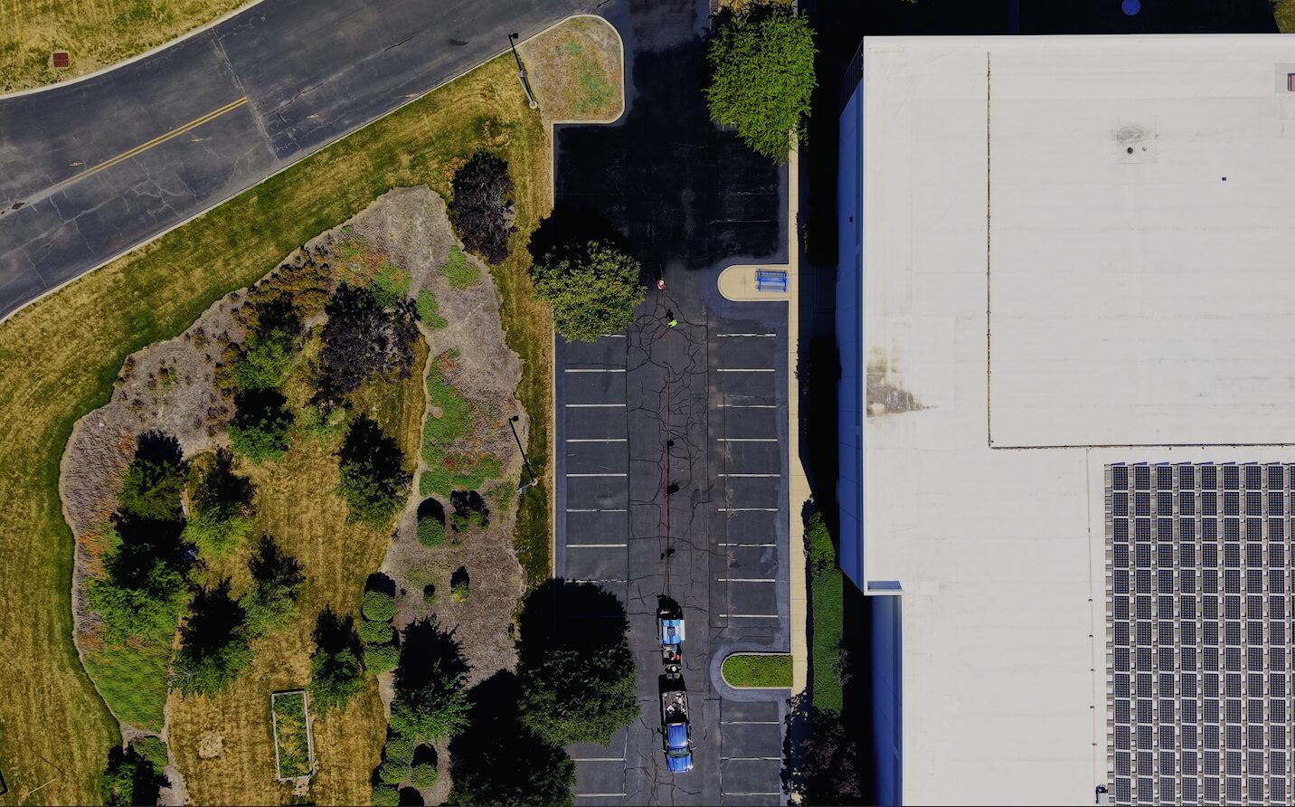 Spray-applied commercial sealcoating in phased zones